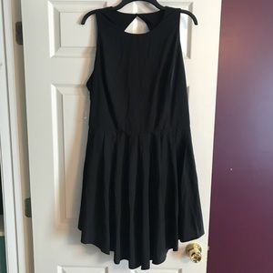 Black romper with skirt overlay.